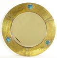 21. A fine Arts and Crafts period hammered brass framed mirror..